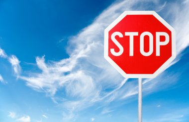 Stop sign with a cloudy sky clipart