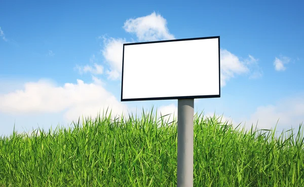 Advertising billboard on a green grass — Stock Photo, Image