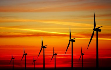 Wind turbines farm at sunset clipart