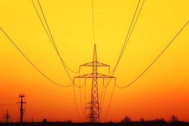 Electricity pylons at sunset clipart