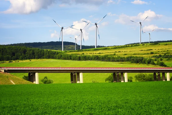 Wind turbines over the highway — Stockfoto