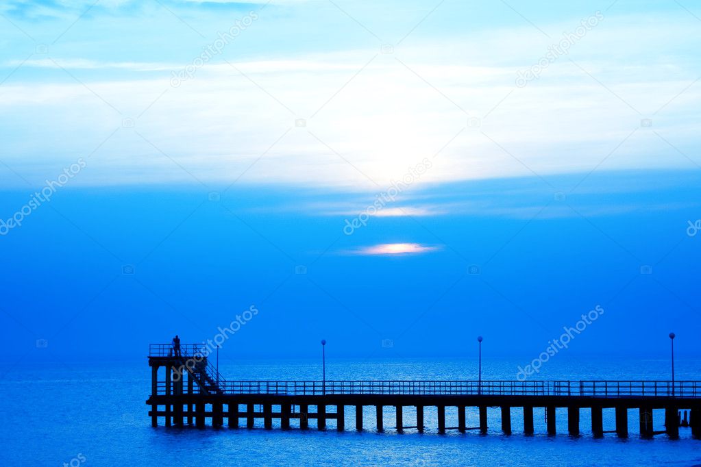 Couple on a pier at sunset