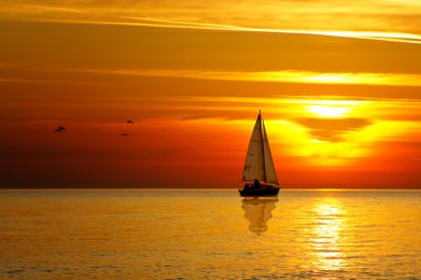 Drifting boat on a sunset clipart