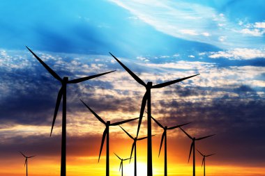 Wind turbine farm over sunset clipart