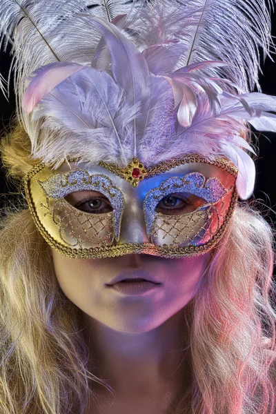 Close up portrait of young woman wearing mask on color back — Stock Photo, Image