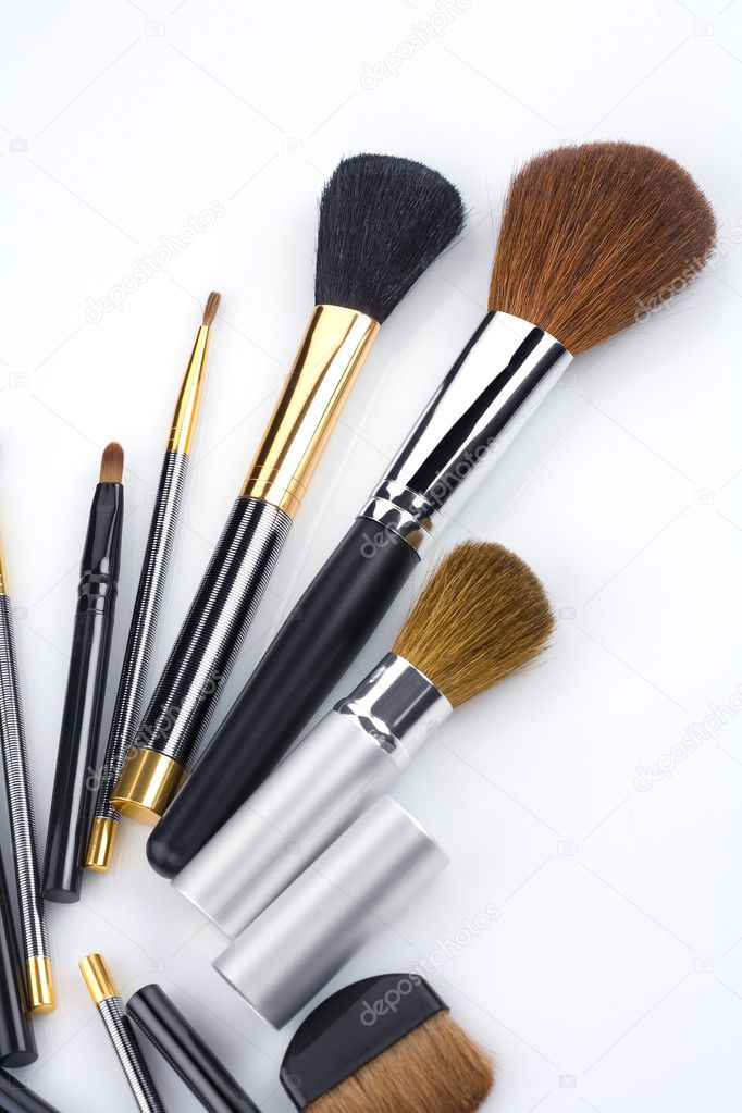 Close up view of different brushes on white back