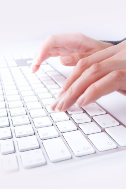 Close up view of female hands touching computer keyboard