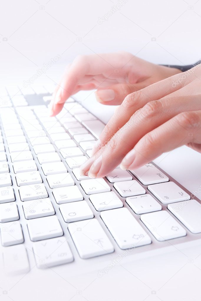 Close up view of female hands touching computer keyboard