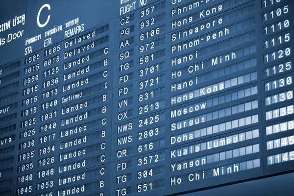 Close up view of airport time-table blue toned — Stock Photo, Image