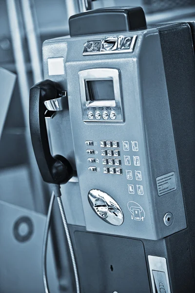 Close up vista do telefone público em azul de volta — Fotografia de Stock