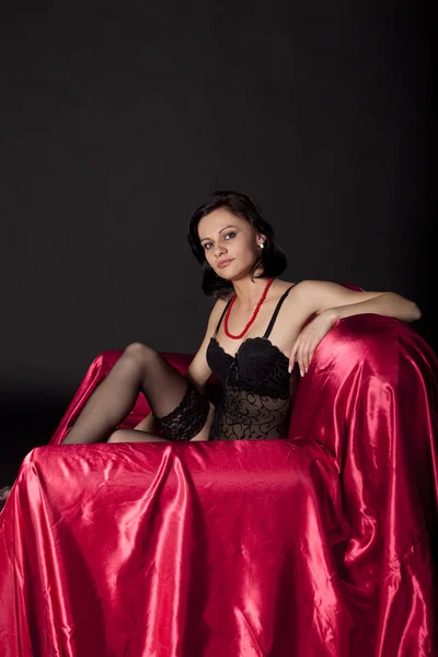 Сексуальна жінка в чорній білизні на атласному ліжку — стокове фото