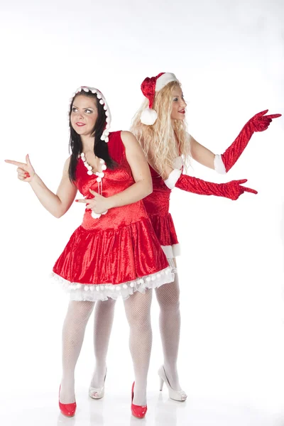 Två sexiga santa tjejer att ha kul på en julfest — Stockfoto