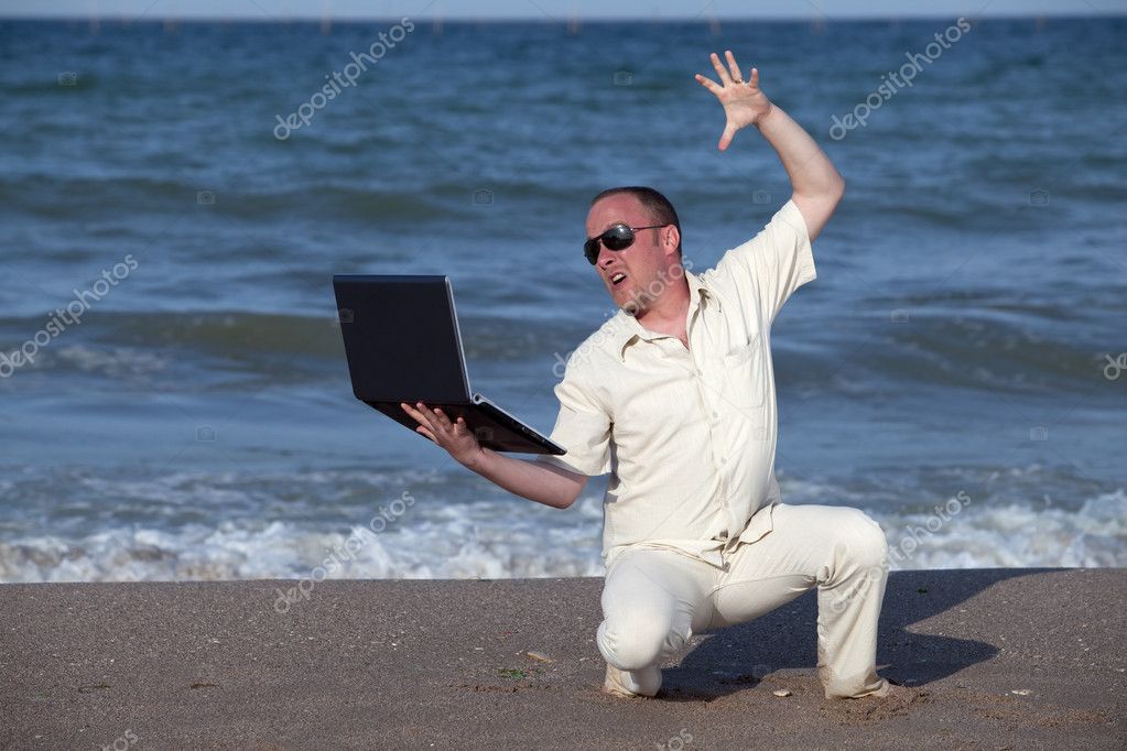 Angry man punching laptop at the beach — Stock Photo © IgooAna #4639816
