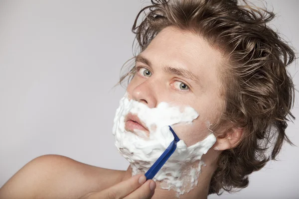 stock image Sexy young man shaving with razor. High resolution image. See more in my portfolio