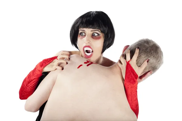 Spooky vampire woman biting a man — Stock Photo, Image