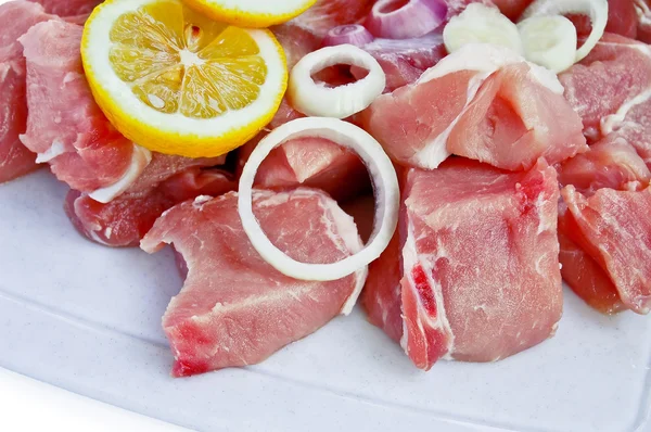 Sliced pork with onion and lemon — Stock Photo, Image