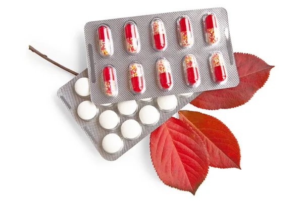 Medications with red leaves — Stock Photo, Image