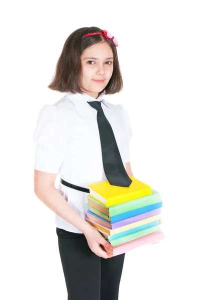 De schoolmeisje houdt leerboeken — Stockfoto