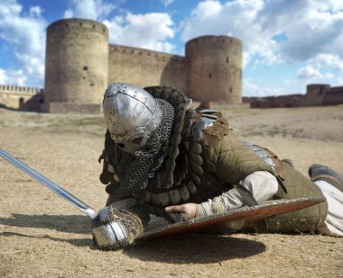 Medieval warrior defeated lying inside the fortress Belgorod Ukrai clipart