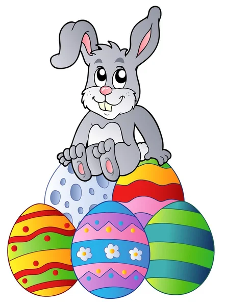 在复活节彩蛋堆上的小兔子 — 图库矢量图片