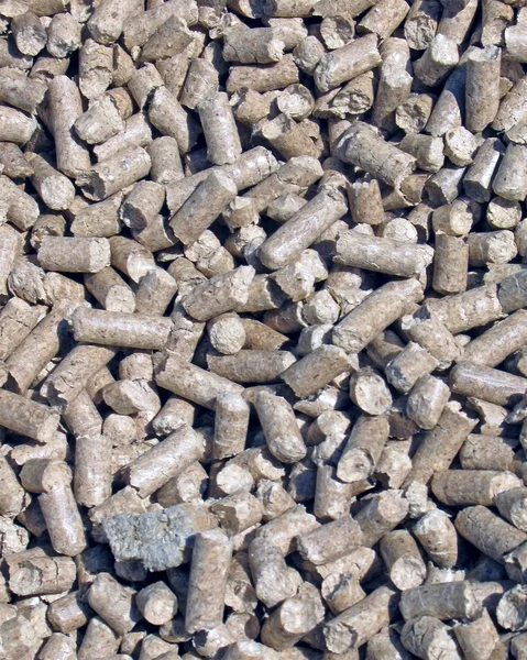 Brown briquette heap background, natural fuel — Stock Photo, Image
