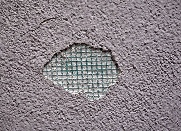 Abstract green grid hole in wall background, texture close seup — стоковое фото