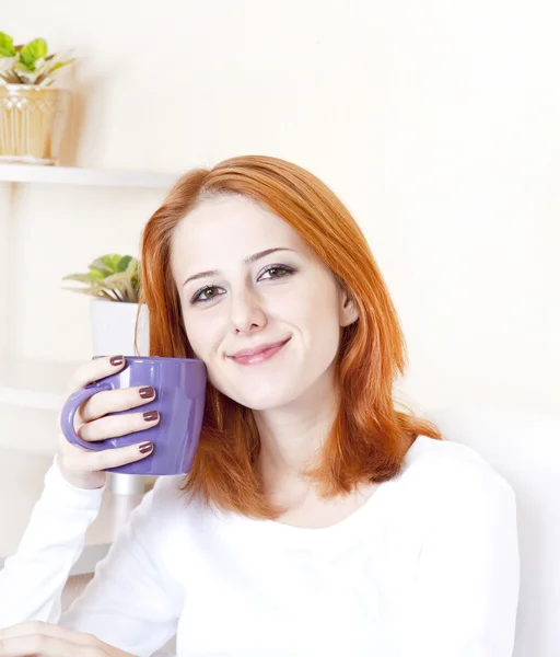 Portrait of red-haired girl with violet cup. — Stock Photo, Image