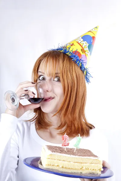 Red-haired with wine glass and cake celebrate her 21th birthday. — Stock Photo, Image