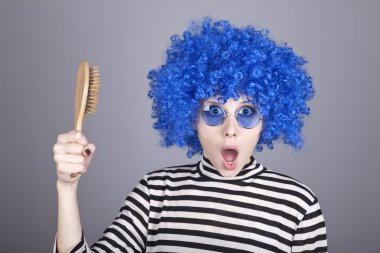 Surprised blue hair girl with comb. clipart