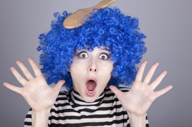 Surprised blue hair girl with stuck comb. clipart