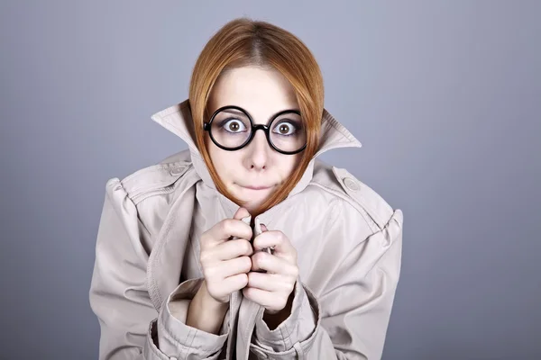 Hiding red-haired girl in glasses and cloak. — Stock Photo, Image