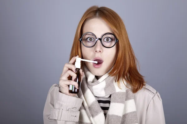 Chill red-haired girl in glasses and scarf with spray. — Stock Photo, Image