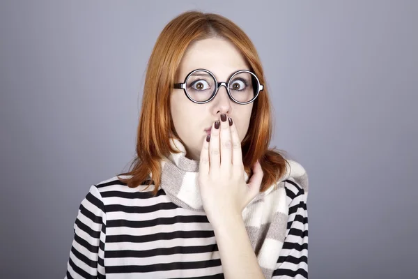 Surprised red-haired girl in glasses and scarf. — Stock Photo, Image