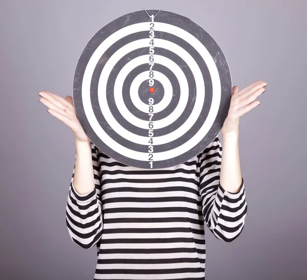 Girl with dartboard in place of head. — Stock Photo, Image