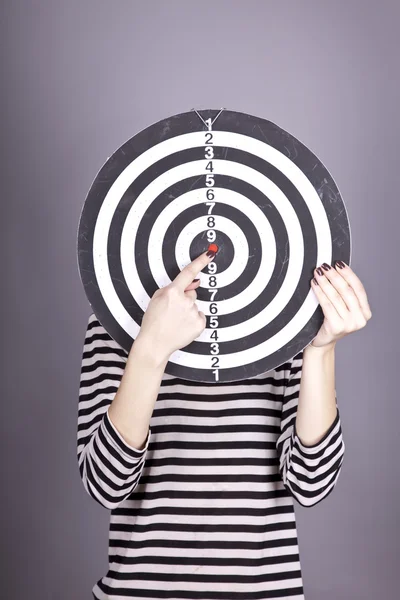 Girl with dartboard in place of head. — Stock Photo, Image