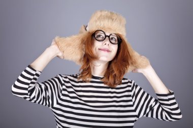 Surprise girl in winter cap and glasses.