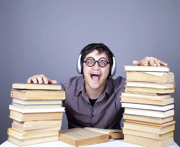The young student with the books and headphone isolated. — Stock Photo, Image