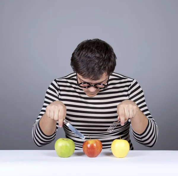 Die jungen enttäuschten Männer mit drei Äpfeln — Stockfoto