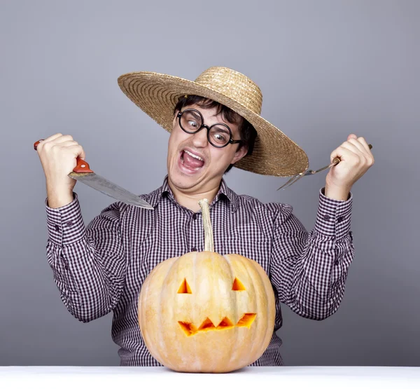 Funny men try to eat a pumpkin. — Stock Photo, Image