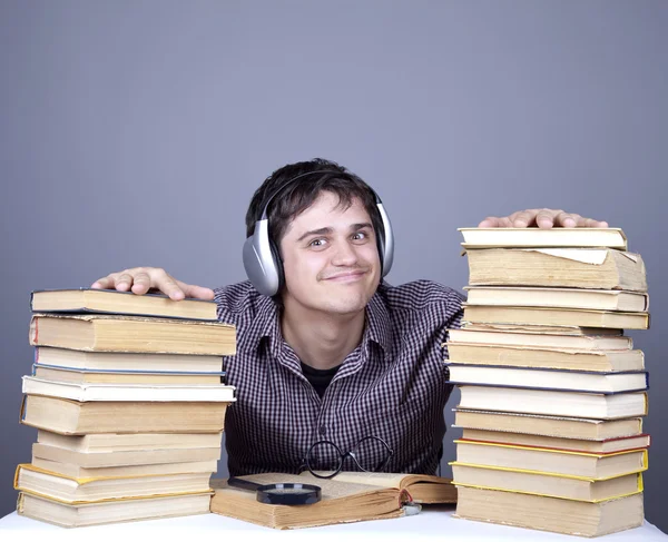 The young student with the books and headphone isolated. — Stock Photo, Image