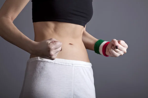 Beautiful and strong women 's abs with metre . — стоковое фото