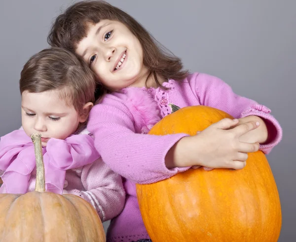 Two little sisters with pumpkin — Stock Photo, Image