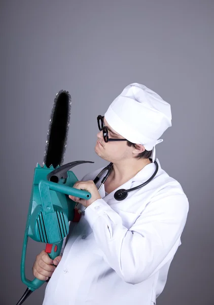 Crazy doctor with portable saw. — Stock Photo, Image