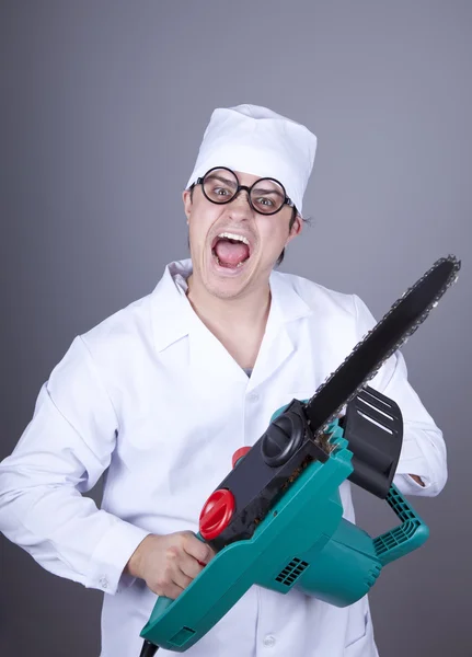 Crazy doctor with portable saw. Royalty Free Stock Images