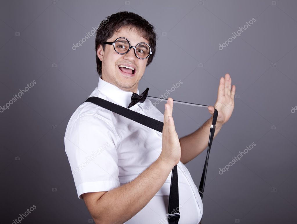 Portrait of funny fashion men in suspender with bow tie and glas ...