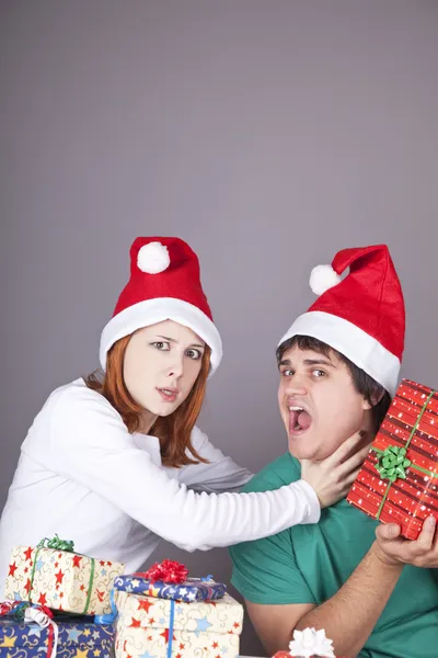 女孩扼杀她的男朋友的圣诞礼物. — 图库照片