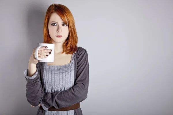 Portrait of red-haired girl with cup. — Stock Photo, Image