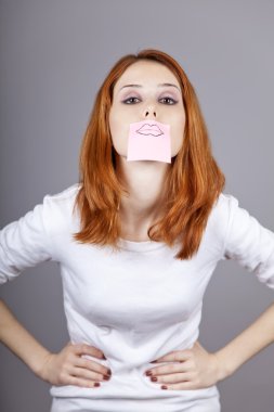 Portrait of red-haired girl with colorful funny stickers on mout clipart