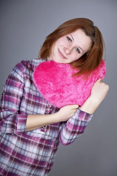 Red-haired girl with heart toy. — Stock Photo, Image