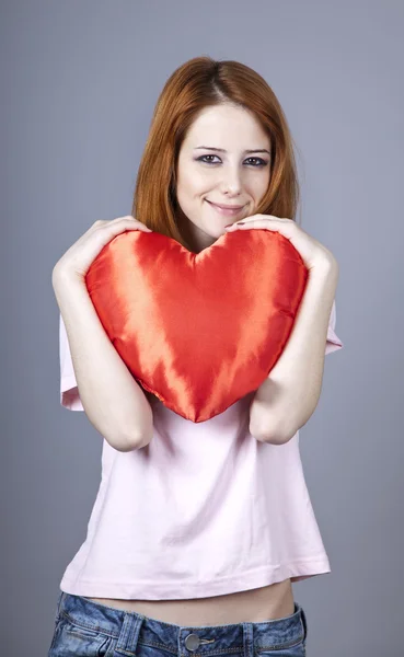 Beautiful red-haired girl with toy heart. — Stock Photo, Image